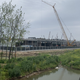 A swamp separates the factory from the main road.